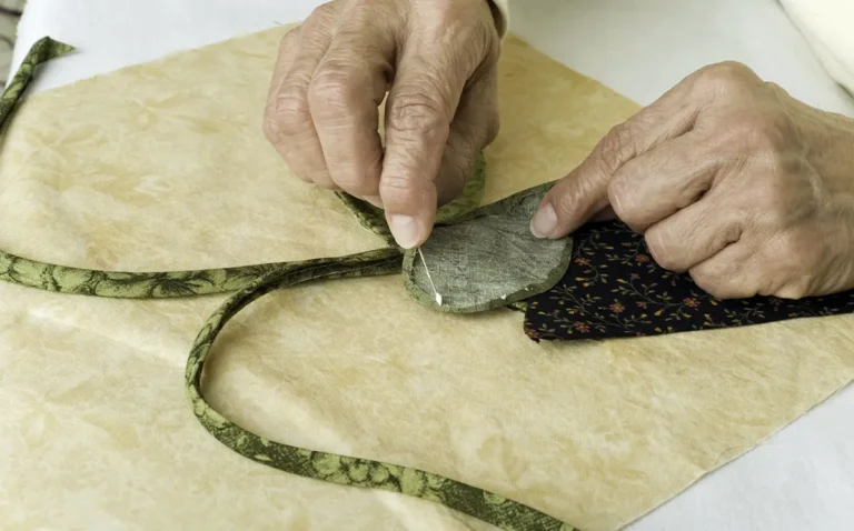 Worker applying fabric glue on cloth